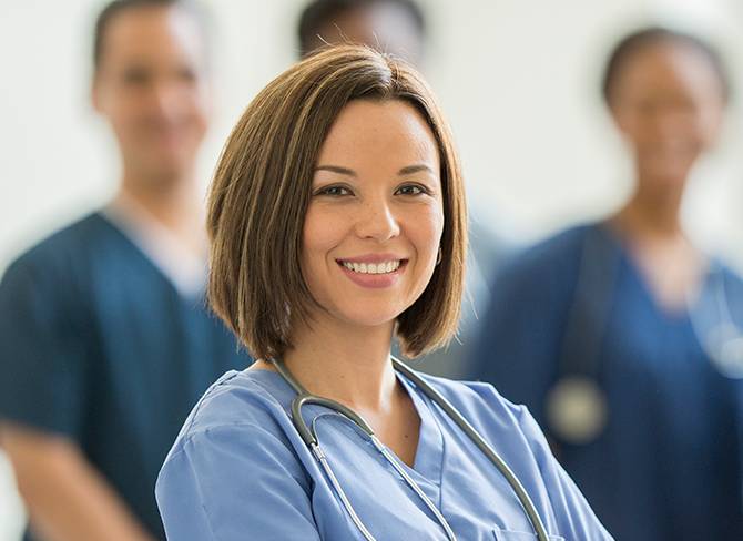 smiling woman in a nurse's uniform