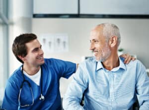 a male nurse attending an old man patient - Advantage Medical Professionals