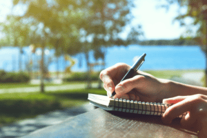 hands-journal-writing-outdoors